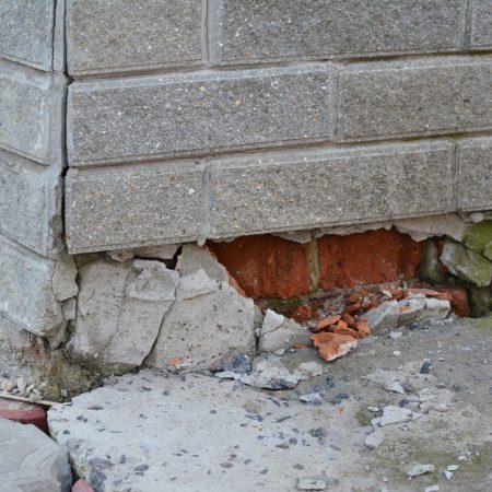 Foundation house wall damage from wetness. Foundation walls without waterproofing. Cracked foundation wall corner.